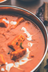 Paneer Butter Masala or Cheese Cottage Curry in serving a bowl or pan, served with or without roti and rice