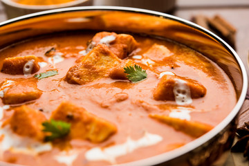 Paneer Butter Masala or Cheese Cottage Curry in serving a bowl or pan, served with or without roti and rice