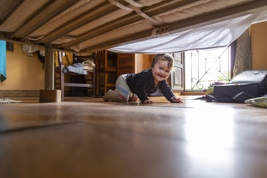 Cheerful Toddler Looking Under Bed