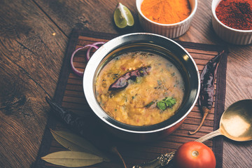 Dal Tadka Fry / Indian Lentil Curry served in a bowl with rice and roti, selective focus
