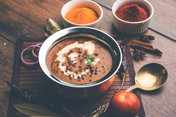 Dal makhani / makhni is a popular dish from India. Made with ingredients like whole black lentil, butter and cream. Served with Naan/roti and rice