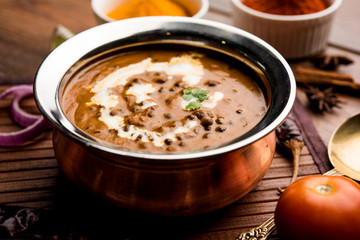 Dal makhani / makhni is a popular dish from India. Made with ingredients like whole black lentil, butter and cream. Served with Naan/roti and rice