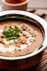 Dal makhani / makhni is a popular dish from India. Made with ingredients like whole black lentil, butter and cream. Served with Naan/roti and rice