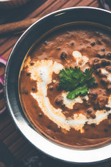 Dal makhani / makhni is a popular dish from India. Made with ingredients like whole black lentil, butter and cream. Served with Naan/roti and rice