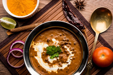 Dal makhani / makhni is a popular dish from India. Made with ingredients like whole black lentil, butter and cream. Served with Naan/roti and rice