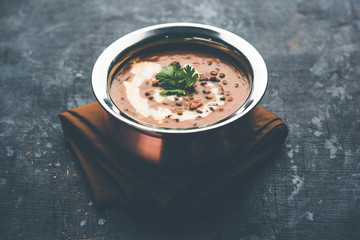 Dal makhani / makhni is a popular dish from India. Made with ingredients like whole black lentil, butter and cream. Served with Naan/roti and rice