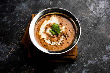 Dal makhani / makhni is a popular dish from India. Made with ingredients like whole black lentil, butter and cream. Served with Naan/roti and rice