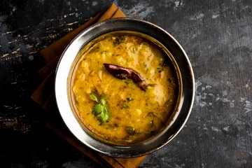 Fototapeten Dal Tadka Fry / Indian Lentil Curry served in a bowl with rice and roti, selective focus © Arundhati