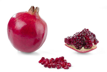 Pomegranate, whole, piece and grain isolated on white. Selective focus.