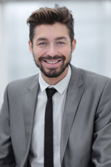 Portrait of a young businessman at the railing in the office