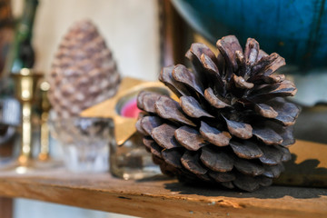 Close up of vintage christmas ornaments pine cone on wooden table with loft concrete blurred...