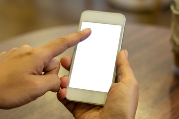 hand woman using a telephone, empty screen smart phone on wooden table In home office. with clipping path