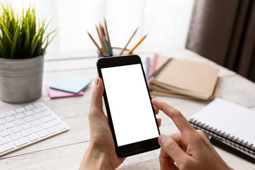 hand woman using a telephone, empty screen smart phone and computer on wooden table In home office. with clipping path