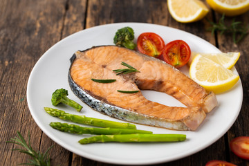 Salmon Grilled on a white plate on wooden table