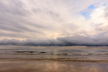 Storm clouds over the sea. Calm and moody seascape with a dramatic sky before storm.