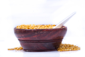 Dried fenugreek seeds isolated on white background