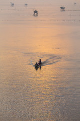 Beautiful Sunrise in morning with Fishing boat at Bangtaboon , petchaburi thailand