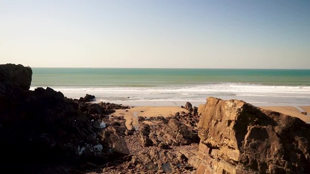 Cliffs and the sea on a beach in Cornwall Bude