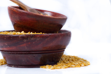 Dried fenugreek seeds isolated on white background
