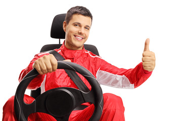 Race driver in a car seat making a thumb up sign © Ljupco Smokovski