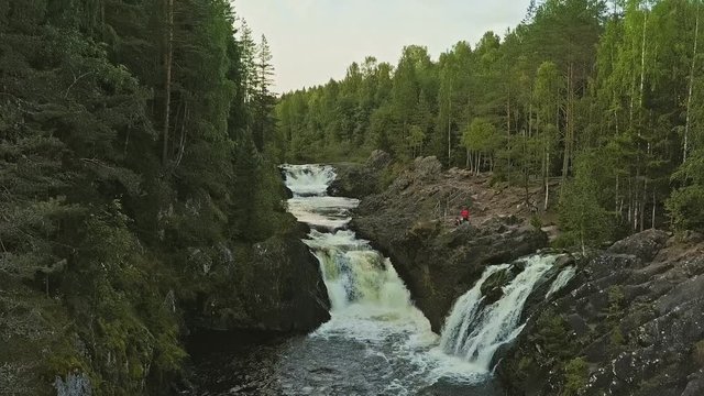 Aerial footage of a Karelian waterfall Kivach, full water stream main view, beautiful nature, foam on water