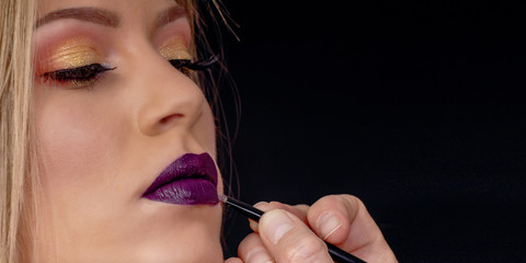 Make up in process, Makeup artist applies lipstick, painting lips
