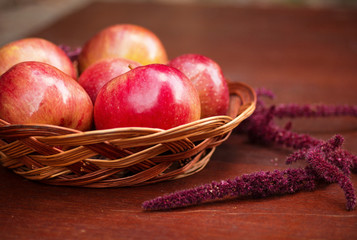 Apples in a basket on a wooden table