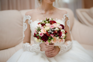 bride holds a bouquet, the bride's bouquet, wedding day, bride in a wedding dress