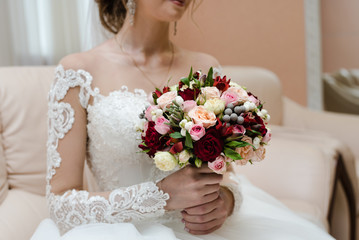 bride holds a bouquet, the bride's bouquet, wedding day, bride in a wedding dress
