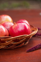 Apples in a basket on a wooden table