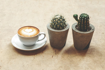 Cup of cappuccino coffee concept with cactus