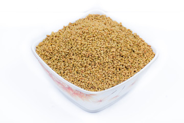 Dried fenugreek seeds isolated on white background