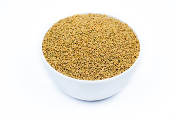 Dried fenugreek seeds isolated on white background