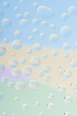 close-up view of transparent rain drops on light abstract background