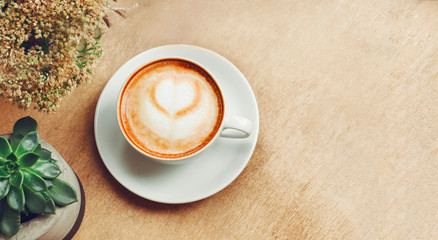 Cup of cappuccino coffee concept with cactus
