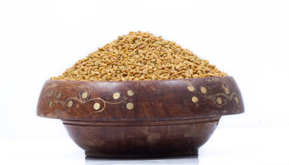 Dried fenugreek seeds isolated on white background