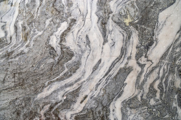 Curly pattern on marble stone for background. Natural marble texture. Marble from canyon Ruskeala. Russia.