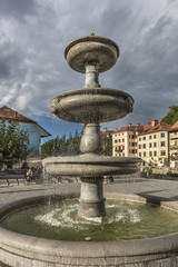 Fototapeta na wymiar Fountain in Novi trg (city square) near river Ljubljanica in Ljubljana, Slovenia