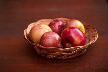 Apples in a basket on a wooden table