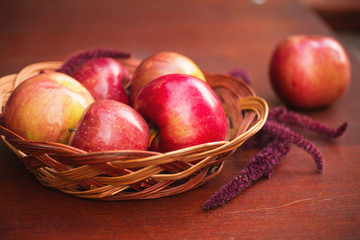 Apples in a basket on a wooden table