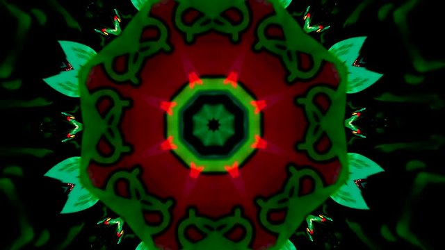 Video en forma de caleidoscopio de mandala giratorio y cambiante que se abre en figuras geom&eacute;tricas formadas con movimiento en colores vibrantes y fondo negro.