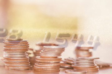 Double exposure Rows of coins of Credit cards on the table,finance and business concept,Money,soft focus and blurred style,dark tone.