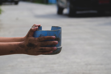 Young boy homeless holding ceramic plate with hungry and need food. Shelter concept. 