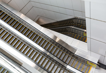 Modern interior design, modern escalators, chrome escalators. Black and White , monochrome, abstract artistic view. Modern art. Steel design. Architecture.