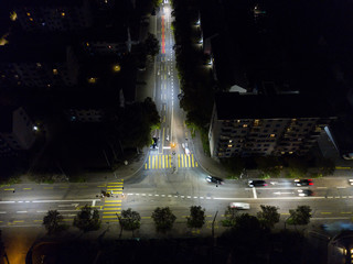 Aerial view of european city in night with bright lights and streets with cars