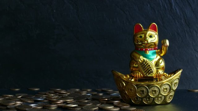 Maneki Neko Japanese lucky cat waving paw and many different coins