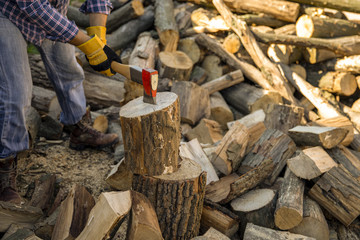 The worker is working the ax. Ax close up. An ax in a tree chopping action. A man chops off a tree with an ax with dust and movements.