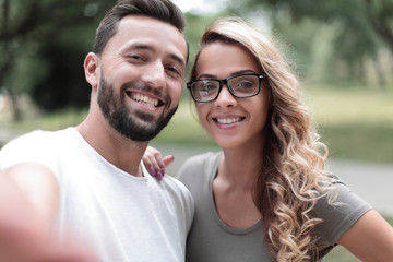 smiling young couple on background of city Park