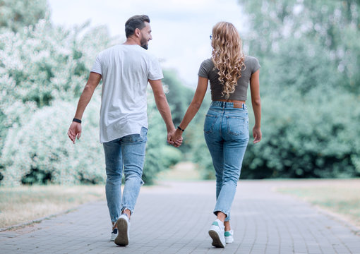 Couple in love walking in park holding hands