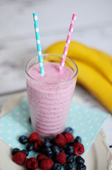 glass of smoothie with fruits and fresh berries